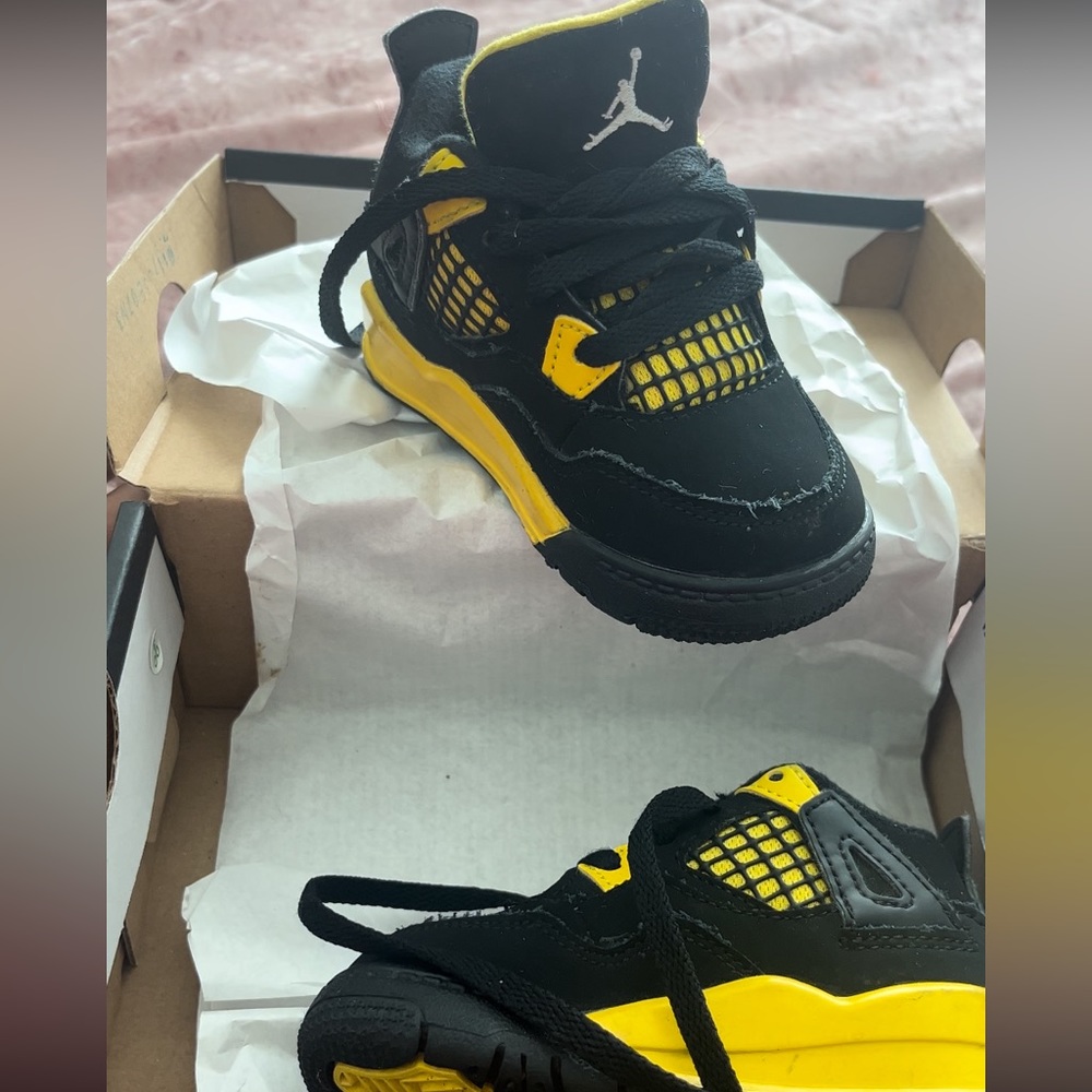 Black & yellow Jordan 4s